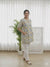 blue and yellow floral print tunic top with white trousers.